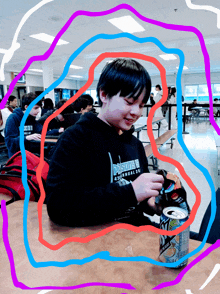 a boy sitting at a table with a can of diet pepsi in front of him