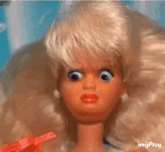 a close up of a doll 's face with a surprised look on it 's face .