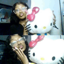 a girl wearing glasses is holding a hello kitty doll .