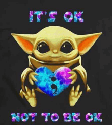 a baby yoda is holding a heart with a comma in it and the words `` it 's ok not to be ok '' .