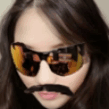 a woman wearing sunglasses with a fake mustache