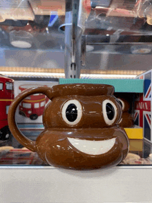 a mug that looks like a poop with a big smile on it