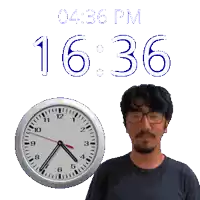 a man with glasses stands in front of a clock that says 16:36 pm