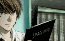 a man holding a death note in front of a shelf of books