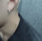 a close up of a person 's ear and neck with earrings .