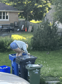 a woman squatting on top of a garbage can that says gilpin on it