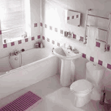 a bathroom with a bathtub , sink , toilet and window .