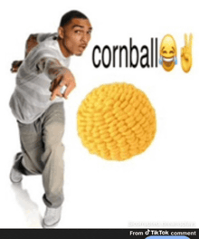 a man is pointing at a cornball that is being thrown