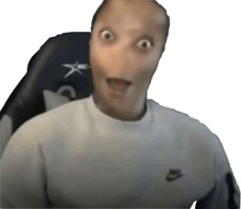 a man wearing a nike shirt is making a surprised face