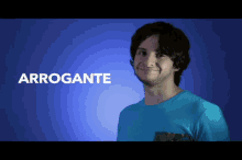 a man in a blue shirt is smiling in front of a blue background with the word arrogante on it