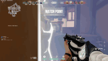 a person is holding a gun in front of a match point screen