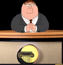 peter griffin from family guy sitting at a desk