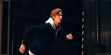 a man is running in a dark room with a blurred background .