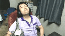 a man wearing headphones is sitting in a chair .