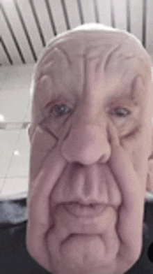 a close up of an elderly man 's face with a mask on .