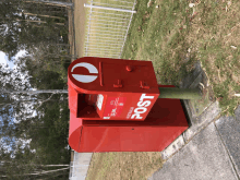 a red mailbox with the word post on the side