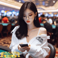 a woman wearing glasses and a shirt that says casino looks at her phone