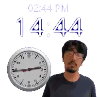 a man with glasses stands next to a clock that says 12:44 pm