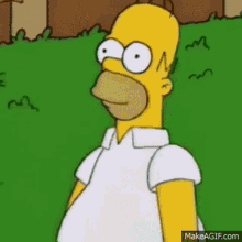 homer simpson is standing in the grass wearing a white shirt and looking at the camera .