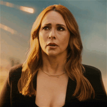 a close up of a woman 's face with red hair