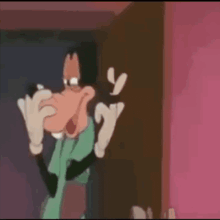 goofy is making a funny face in a cartoon while standing in front of a door .