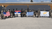 a group of soldiers are posing for a picture with flags from various countries