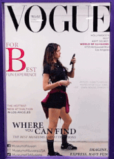 a woman is standing in front of a vogue cover