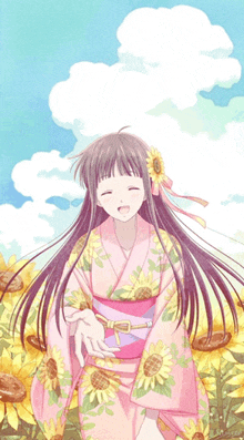 a girl in a pink kimono with sunflowers on it is smiling