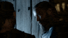 a man with a beard leaning against a wall with the words wherever you go below him