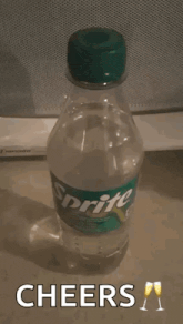 a sprite bottle is sitting on a table with a cheers message