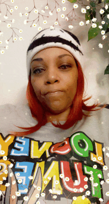 a woman wearing a beanie and a t-shirt that says " yevco " on it