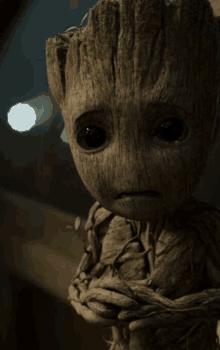 a close up of a baby groot looking sad