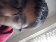 a blurry picture of a person 's face with glasses on