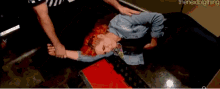 a woman with red hair is laying on her back with the nextbigthing written in the corner