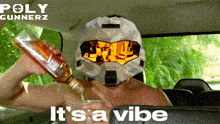 a man wearing a helmet is pouring a drink into a glass with the words " it 's a vibe " below