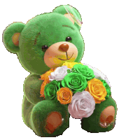 a green teddy bear is holding a bunch of flowers