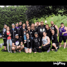 a group of people posing for a picture with one man wearing a shirt that says " i 'm not a freak "