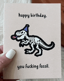 a birthday card with a dinosaur wearing a party hat