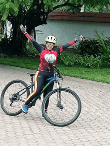 a woman wearing a helmet is riding a bike