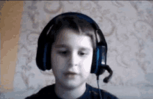 a young boy is wearing headphones and a microphone .