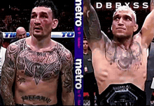 a man with a tattoo on his chest stands next to another man with a belt that says metro