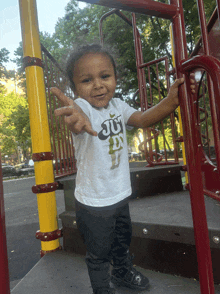 a young boy wearing a white shirt that says jd on it