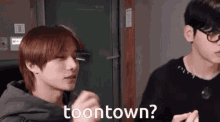 two young men are standing next to each other and one of them is saying toontown ?