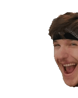 a man wearing a bandana on his head is smiling