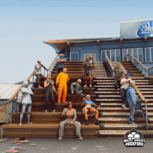 a group of people are standing on a set of stairs with a west coast rockford logo on the bottom