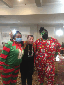 a woman wearing a mask stands next to two other women in pajamas