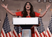 a woman stands at a podium that says 2020