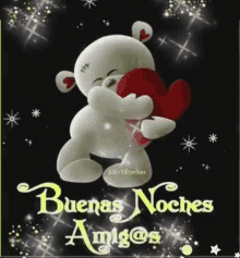 a teddy bear is holding a red heart and says buenas noches amigos