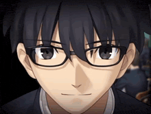 a close up of a person wearing glasses and a black shirt