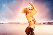 a woman in a bikini stands in the desert
